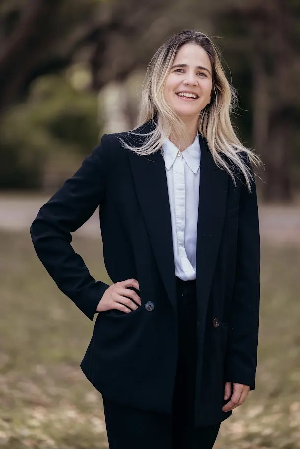 Dr. Camila Carrillo in a suit with a scenic backdrop